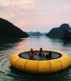 three women sitting on an inflatable floating pool