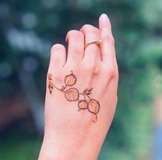 a woman's hand with a flower tattoo on it