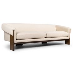 a white couch sitting on top of a wooden frame