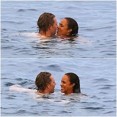 two people in the water kissing each other