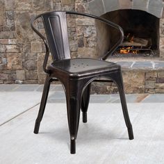 a black chair sitting in front of a fire place