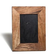 a wooden frame with a black cloth in the center and two small rings on it