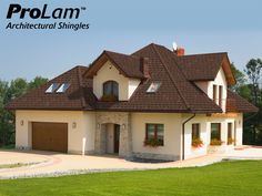 a large house with a green roof and two garages