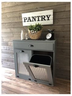 a gray cabinet with trash cans and a sign that says pantry