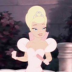 a blonde haired woman dressed as tinkerbell holding a knife in her right hand