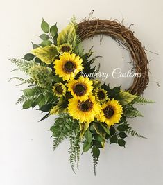 a wreath with sunflowers and green leaves