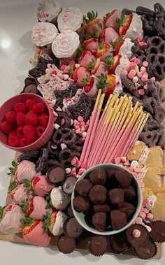 a platter filled with chocolate covered strawberries, strawberries and marshmallows