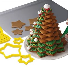 a person is decorating a christmas tree cookie