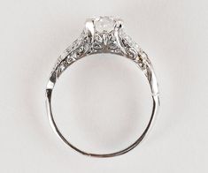 an antique style diamond ring on a white background