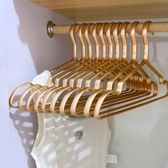 there is a wooden rack with clothes hanging on it