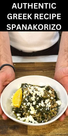 a person holding a plate with food on it and the words authentic greek recipe spanaconzo