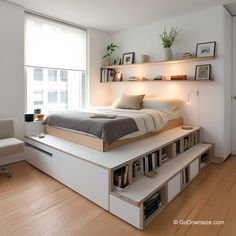 a bed sitting on top of a wooden floor next to a white chair and book shelf