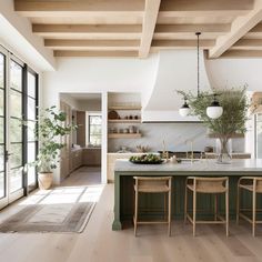 a kitchen with wooden floors and green cabinets