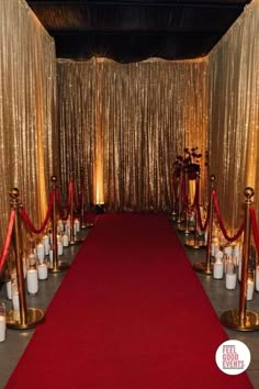 a red carpet is lined up with candles