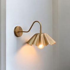 a wall light that is on the side of a wall next to a white wall