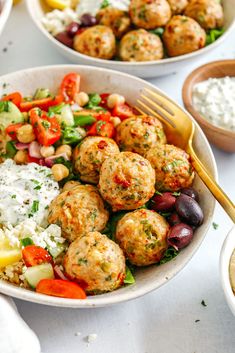 two bowls filled with meatballs and vegetables next to some dips on the side