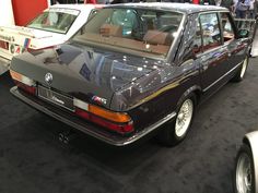 an old bmw car is on display at the show