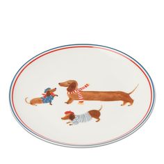 a plate with three dogs on it and one is wearing a sweater, the other has a