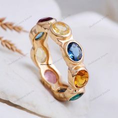 18K Yellow Gold Multi Sapphire Ring Colorful Gemstone Wedding Band Full Eternity Band Minimalist Band Unique Rainbow Band Anniversary Gift Description: Stone: Multi Gemstones (Lab Created) Stone Size: 5 x 2.5 MM Stone Shape: Oval Stone Color - Multi Color Stone cut - Brilliant Cut Finishing- Excellent feel free to contact me if you have any questions  Gemstone color may slightly vary from listed image due to the nature of all natural gemstone or different monitor settings TURNAROUND TIME Your order will be ready for shipment in 4-8 business days. Free economy shipping for US, UK, Germany- 10-15 business days delivery time. shipping upgrade available for US, UK, Germany- 5-7 business days delivery time. Please check shipping times for other countries by entering your country at shipping par Multicolor Round Bezel Set Jewelry, Multicolor Round Jewelry With Bezel Setting, Multicolor Jewelry With Bezel Setting, Multicolor Cubic Zirconia Crystal Ring For Weddings, Multicolor Stackable Cubic Zirconia Jewelry, Rainbow Multi-stone Wedding Jewelry, Rainbow Multi-stone Jewelry For Wedding, Multicolor Ring With Bezel Setting, Multicolor Bezel Set Ring