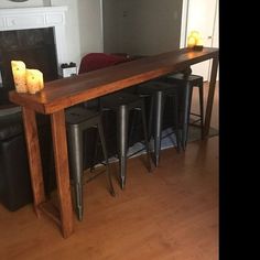 a wooden table with candles on it in a living room