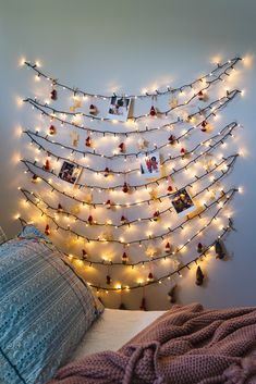 a bedroom decorated with lights and pictures on the wall