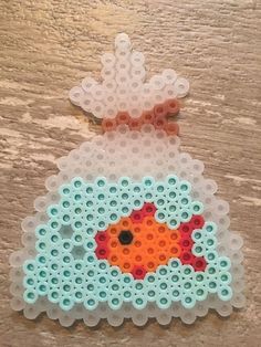 an ornament made out of plastic beads with a fish in the water on it