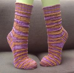 the legs and ankles of a woman wearing socks made out of knitted yarns