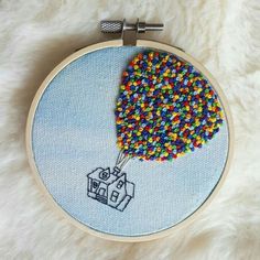 a colorful beaded object is in the shape of a house