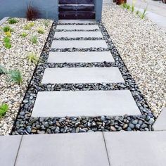 a walkway made out of stones leading to a door