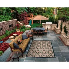 an outdoor living area with patio furniture and umbrellas