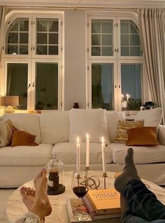 a person laying on the floor with their feet propped up in front of a coffee table