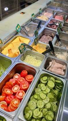 many different types of food in trays on display