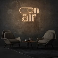 two chairs and a table in front of a green wall with the words backstage on it