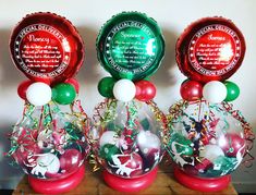 three vases filled with balloons and confetti on top of a wooden table