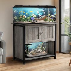 a fish tank sitting on top of a wooden cabinet in a living room next to a couch