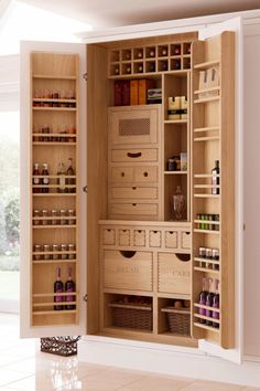 the inside of an empty pantry with drawers and baskets on it's doors is shown