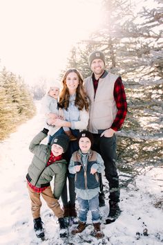 a family poses for a photo in the snow