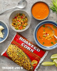 bowls of soup, corn, tortilla chips and other foods are laid out on the table