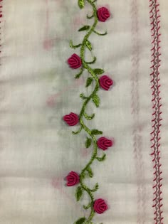 a close up of a piece of cloth with flowers embroidered on the front and back