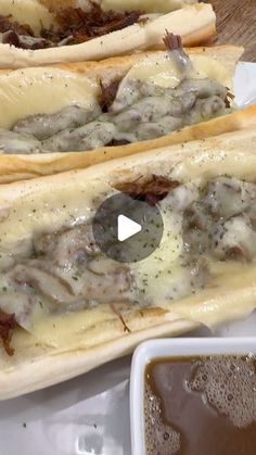 two hot dogs covered in cheese and sauce