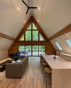 an open living room and kitchen area in a loft style home with wood flooring