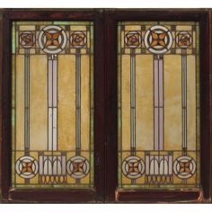 two stained glass doors with decorative designs on the front and side panels, one in brown wood