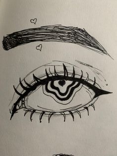 an eye with long eyelashes and hearts drawn on it