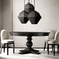 a black and white photo of a dining room table with four chairs around the table