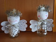 two little angels made out of mason jars with tinsel and silver decorations on them