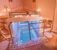 an indoor swimming pool in the middle of a room filled with candles and mirrors on the wall