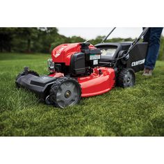 a man is mowing the grass with his lawnmower