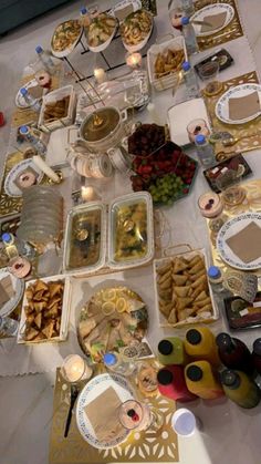 a table topped with lots of plates and bowls filled with different types of food items