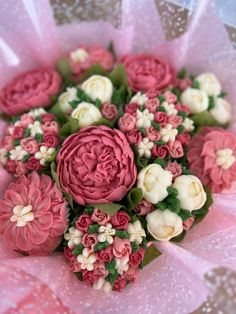 pink and white flowers are arranged in a bouquet