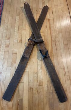 an old pair of scissors laying on the floor in front of a wooden flooring board